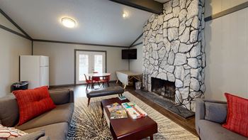a living room with a large stone fireplace